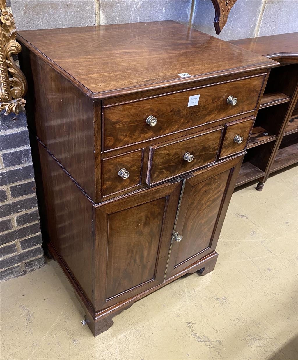 A Regency mahogany cupboard, fitted four drawers over a pair of fielded panelled doors (altered), width 69cm, depth 56cm, height 104cm